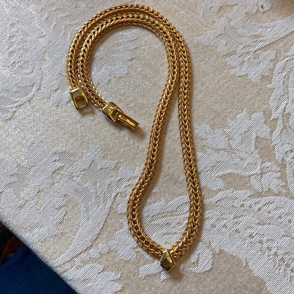 Gold tone chevron emblem necklace. 16”.